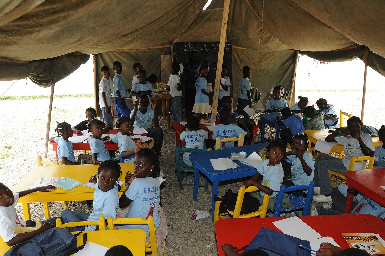 Enfants en classe sous une tente-école en Haïti